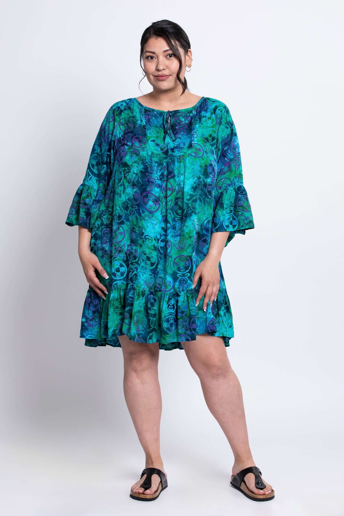 Model wearing Wanda boho tunic dress in vibrant turquoise hues, standing with hands relaxed