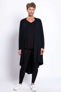 Model in black open-front bamboo duster with leggings and white sneakers, front view