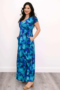 Model in blue floral bamboo maxi dress showing side pockets