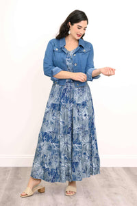 Model in blue floral skirt and matching top, styled with a denim jacket