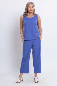 Model wearing blue sleeveless top and cropped Boardwalk pants, front view with hands in pockets