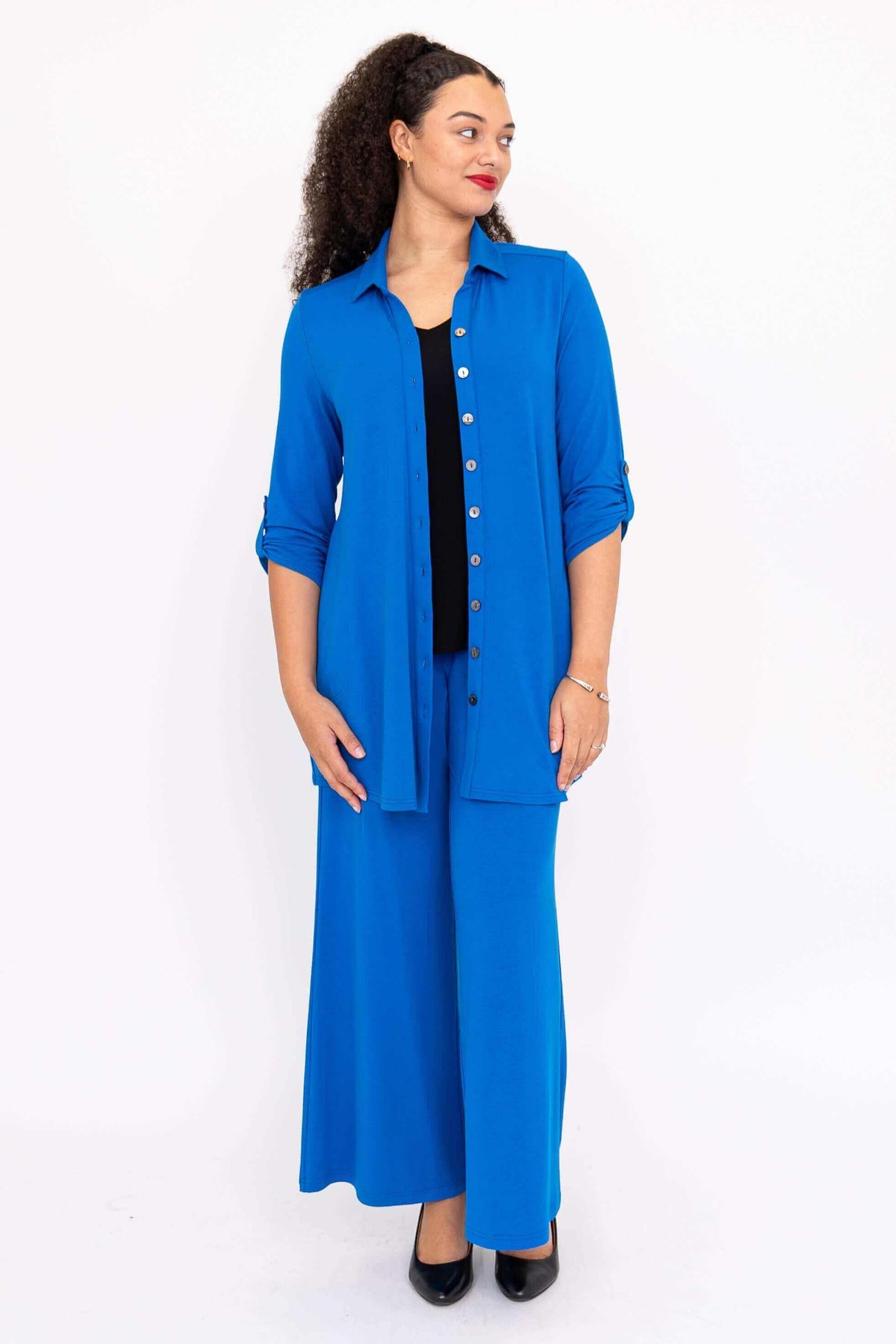 Model in blue wide-leg pants and matching button-up shirt, front view
