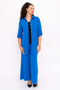 Model in blue wide-leg pants and matching button-up shirt, front view