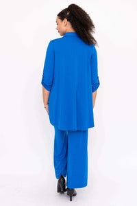 Model in blue wide-leg pants and matching shirt, back view