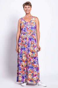 Model wearing a colorful floral sleeveless maxi dress, hands relaxed, front view