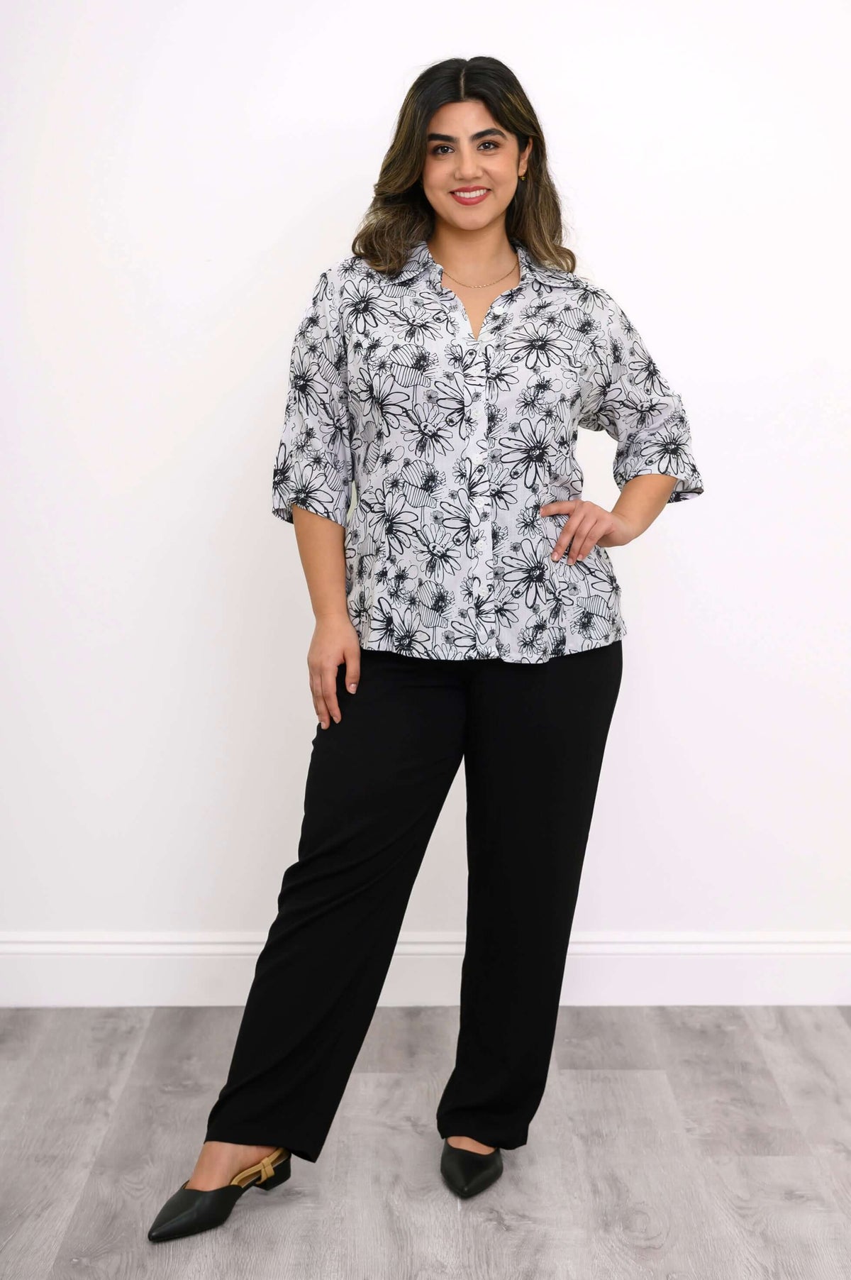 Woman modeling floral bamboo linen blouse with hand on hip