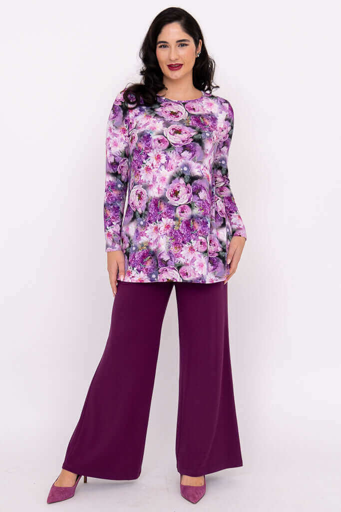 Model wearing purple floral long sleeve tunic with wide leg plum pants