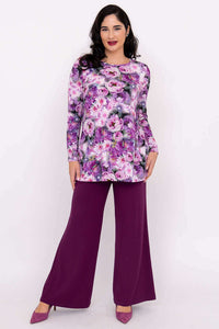 Model wearing purple floral long sleeve tunic with wide leg plum pants