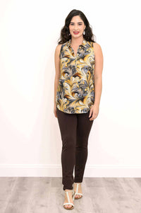 Model standing in golden marble sleeveless top and brown pants, front view