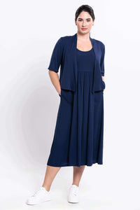 Woman wearing navy midi dress styled with matching open cardigan, front view