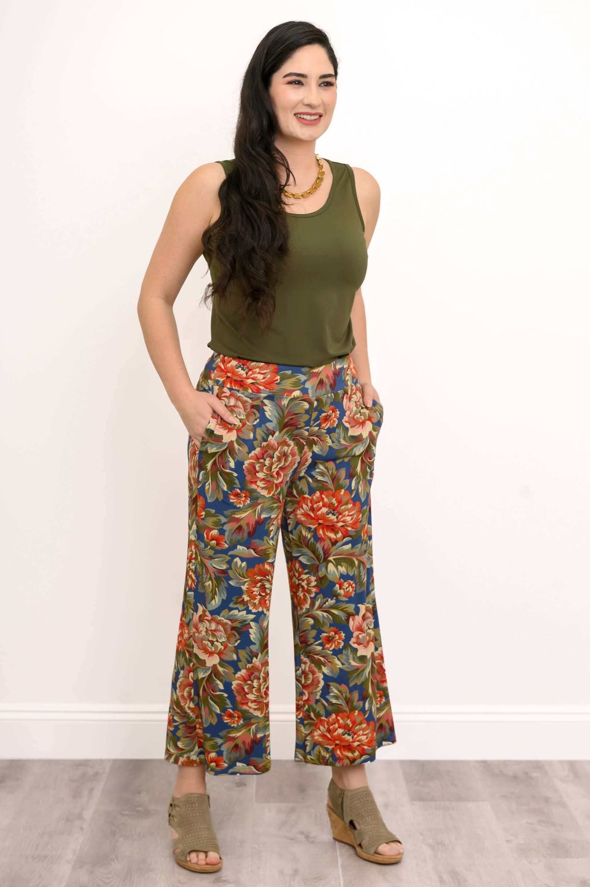 Model with olive tank, hands in pockets of floral wide leg pants