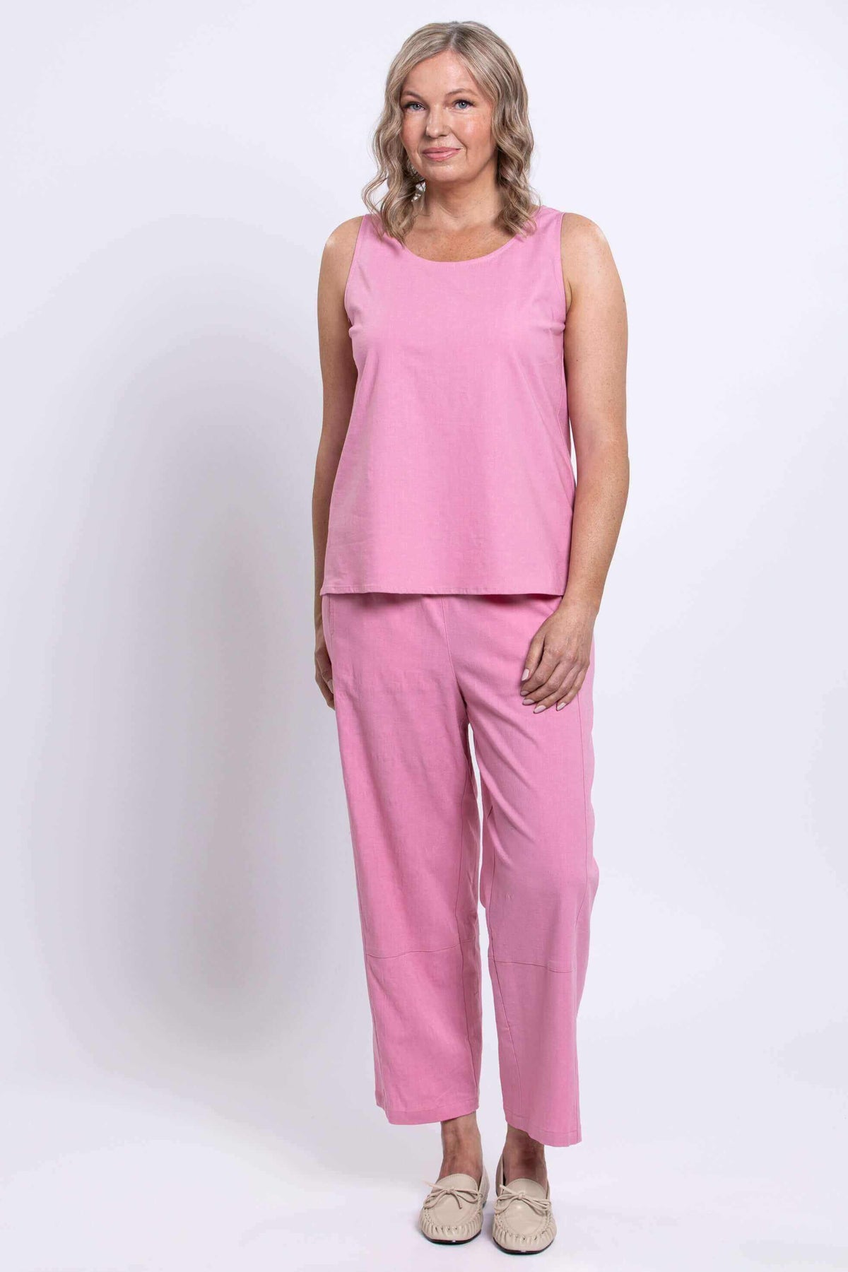 Model standing in pink Boardwalk Pants and coordinating sleeveless top, front view