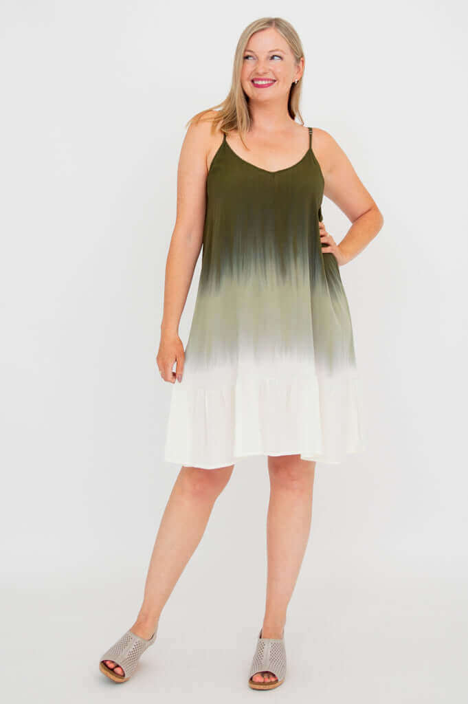 Model posing in olive ombre dress with hands on hip