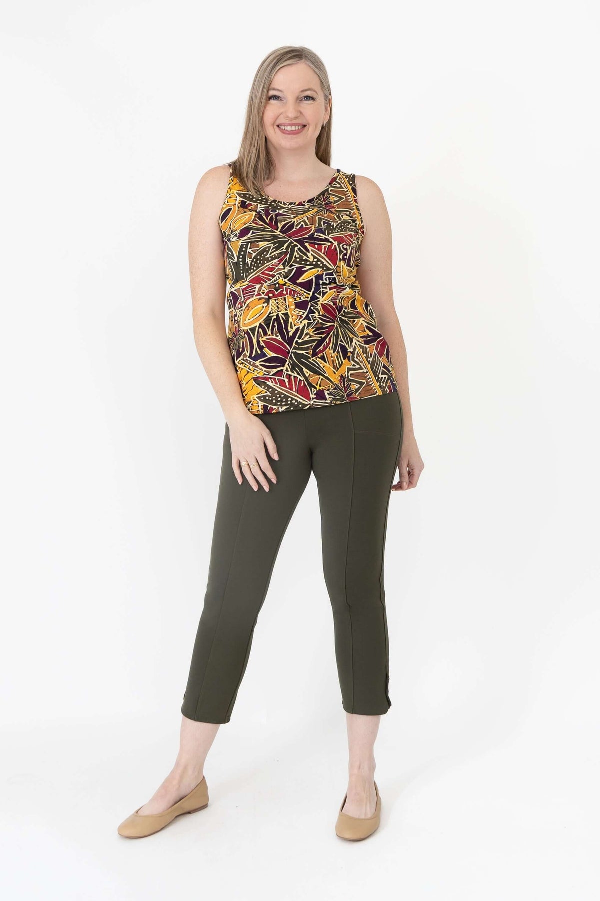 Woman modeling a marigold batik print sleeveless tank top, fashion pose, front view