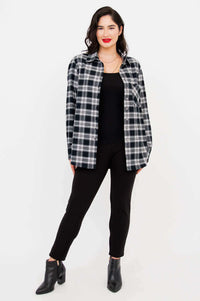 Model posing in Georgia plaid shirt and black pants