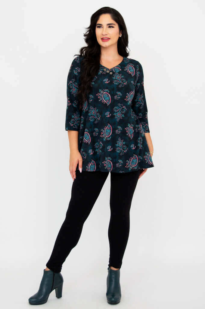 Model posing with one leg forward, wearing paisley print Vana Tunic and leggings