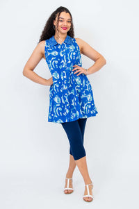 Model posing in sleeveless azure button-up Cissy Tank with pockets