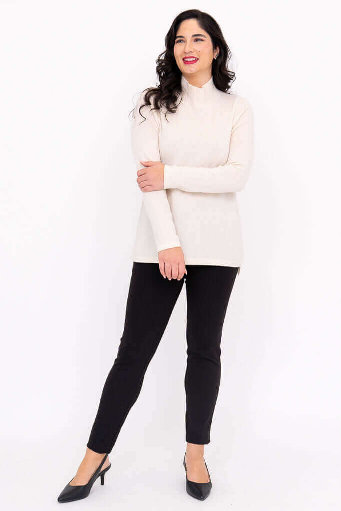 Model posing in cream Simmon Sweater with arms crossed