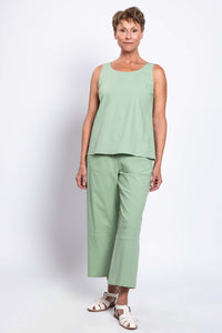 Model posing in sage green sleeveless tank and wide leg pants