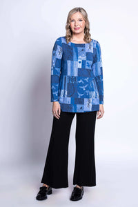 Model showcasing blue patchwork tunic with relaxed fit and black trousers