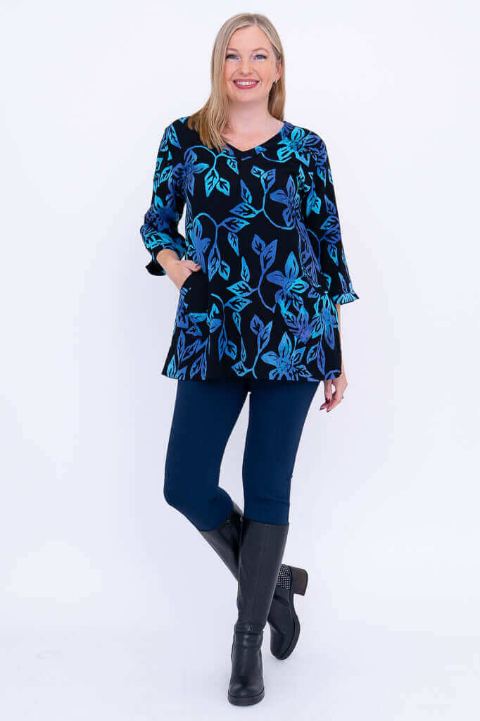 Full body view of woman modeling the Evelyn Top with leggings and boots