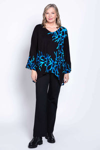 Model showing a black bohemian top with blue coral design, relaxed pose, full body