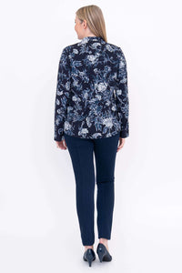 Back view of woman wearing navy floral mandarin collar blouse and navy pants