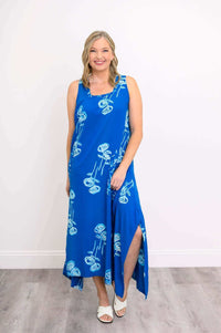 Model posing in a blue floral dress, showing calf-length and side slit details
