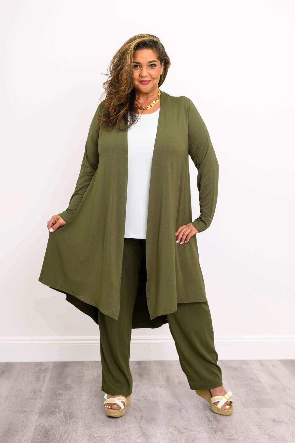 Model showing open front and flowy fit of olive green bamboo duster cardigan