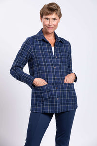 Woman with hands in the pockets of a blue plaid cotton jacket