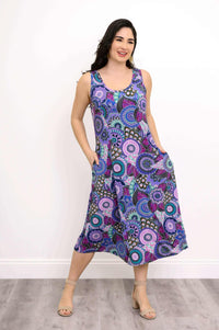 Model posing with hands in pockets, wearing Mandala Garden bamboo tank dress