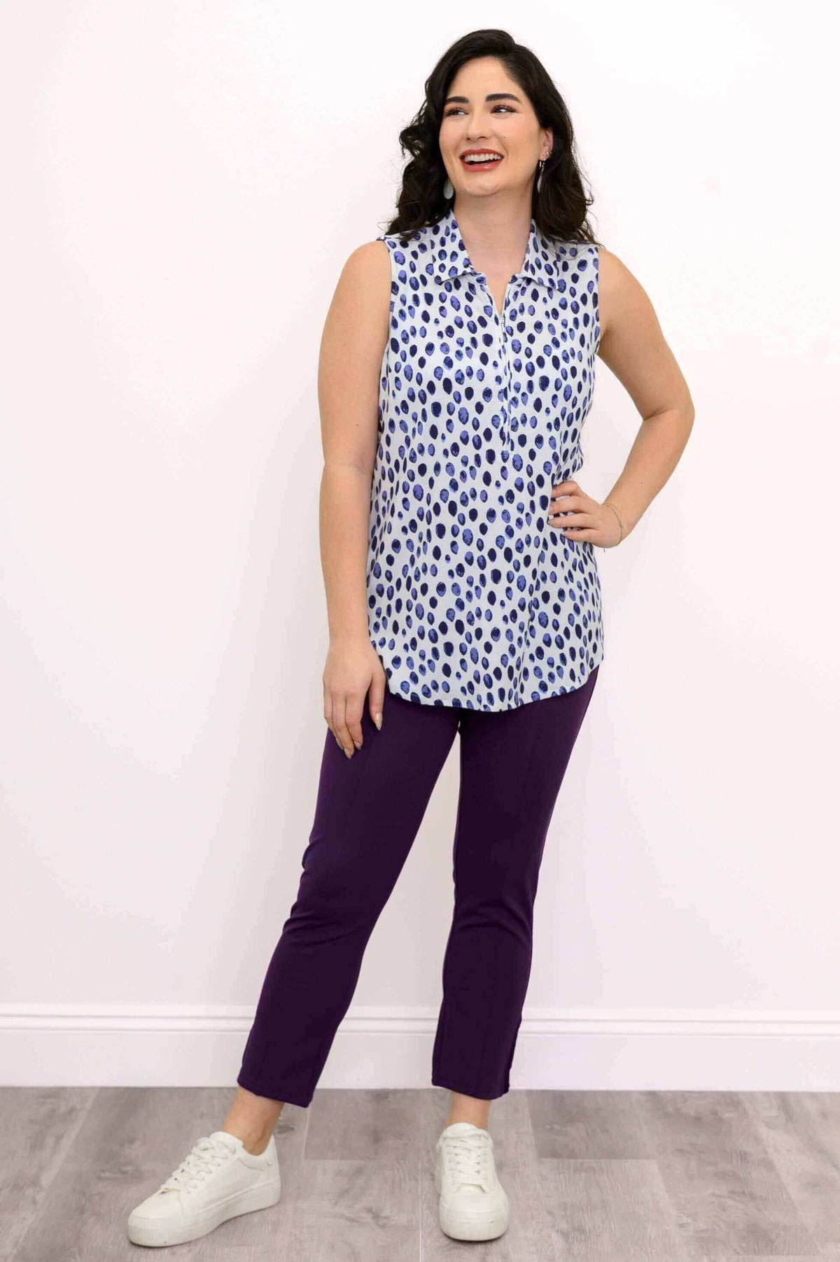 Model smiling and wearing The Hula sleeveless blue spotted tank top