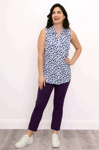 Model smiling and wearing The Hula sleeveless blue spotted tank top