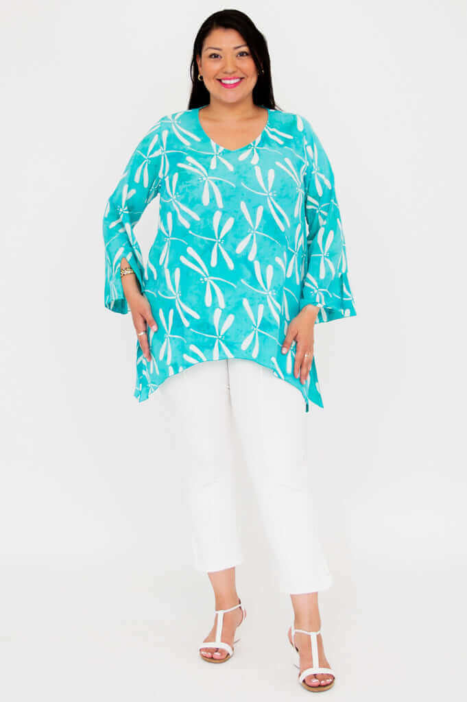 Model standing facing forward in aqua blue Dorothy dragonfly print top