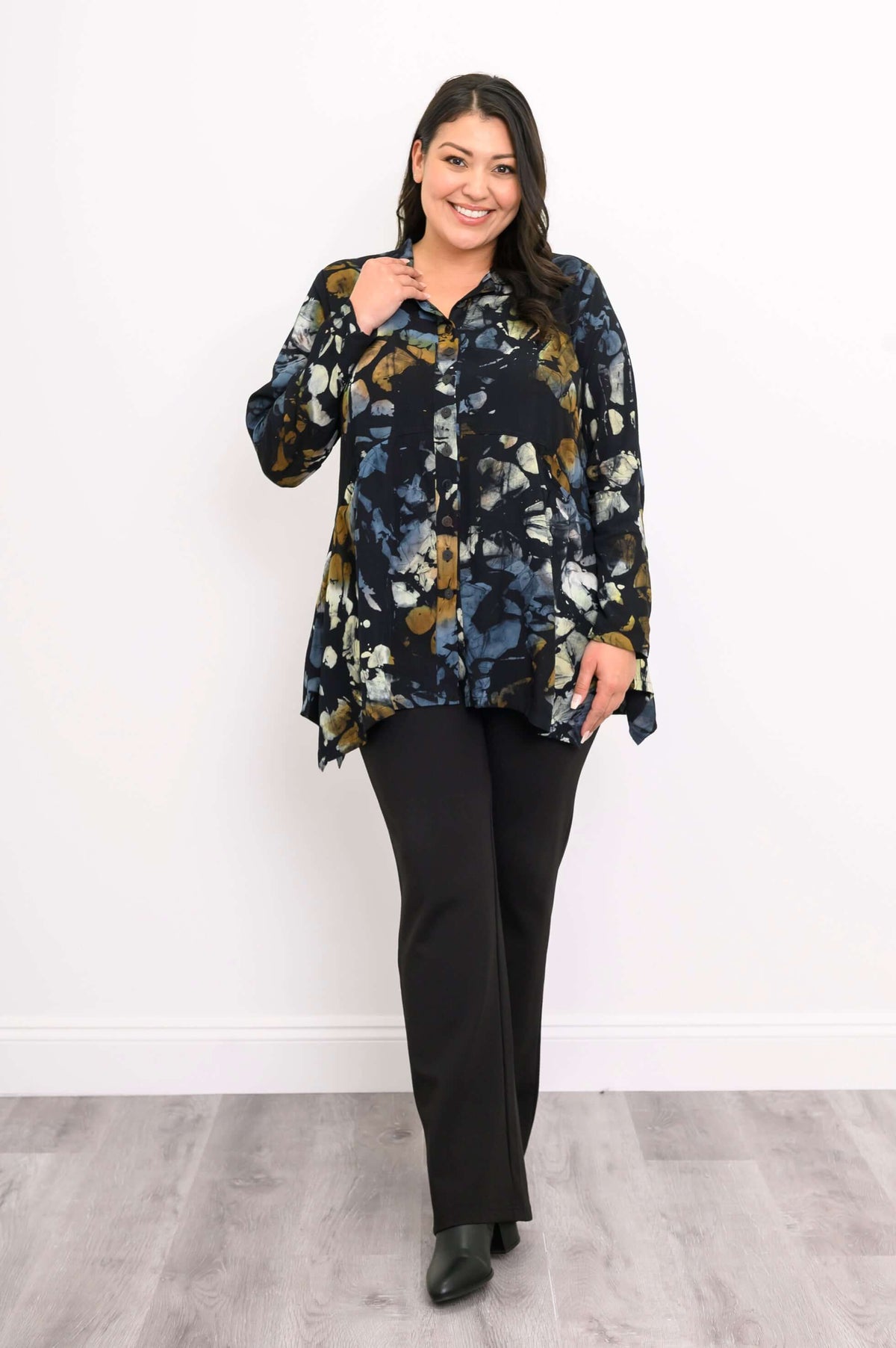 Model walking in Laney Blouse with midnight marble print, smiling