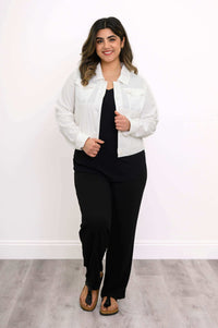 Model walking confidently in white linen jean jacket, hands by her sides
