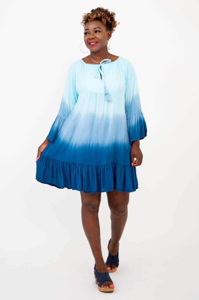 Model walking in Ellie Dress, highlighting the ruffled hem and gradient blue fabric