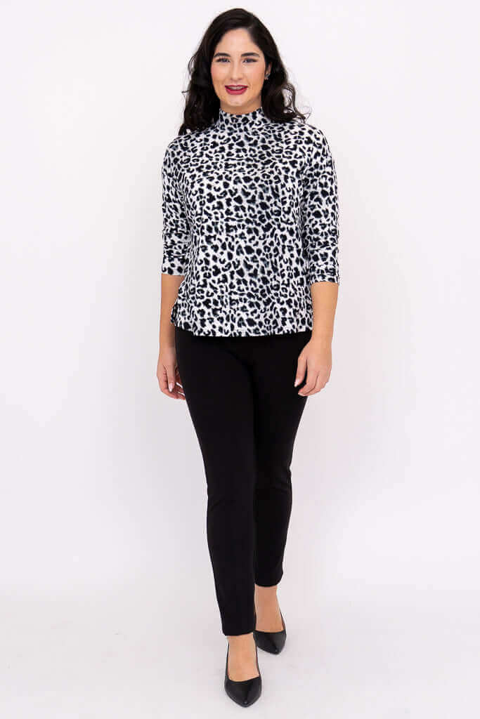 Model walking forward in animal print Highdrop Top and black pants