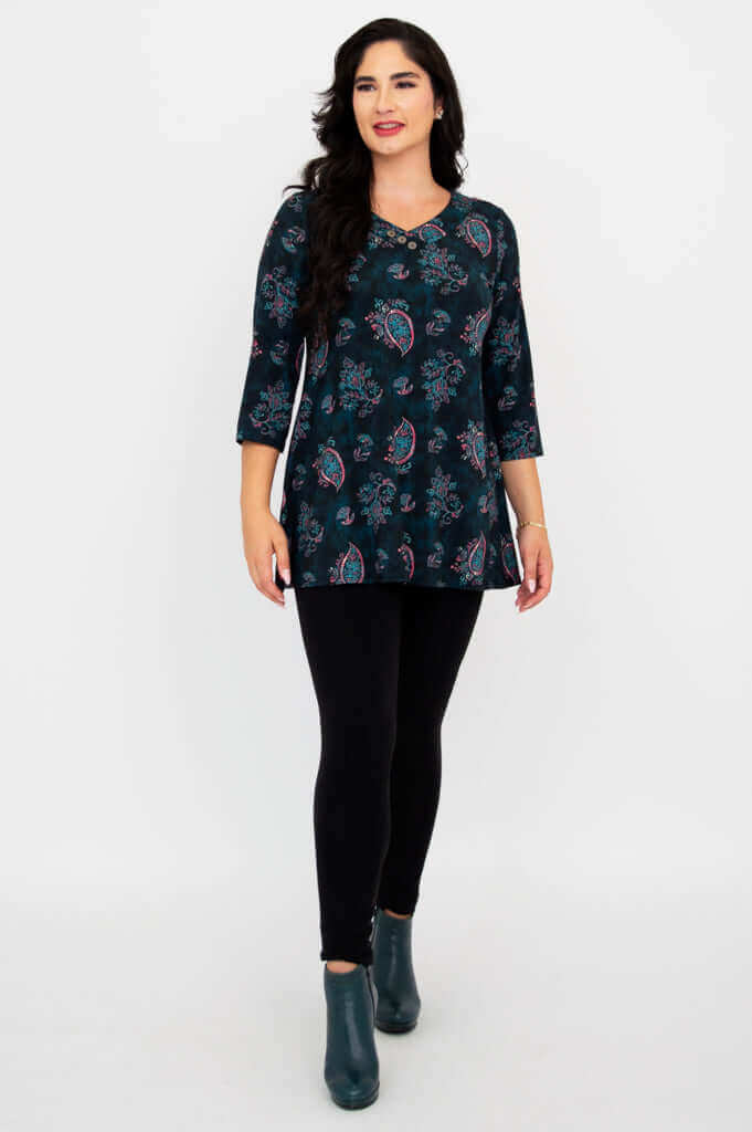 Model walking forward in Vana Tunic, showing full outfit with leggings and boots