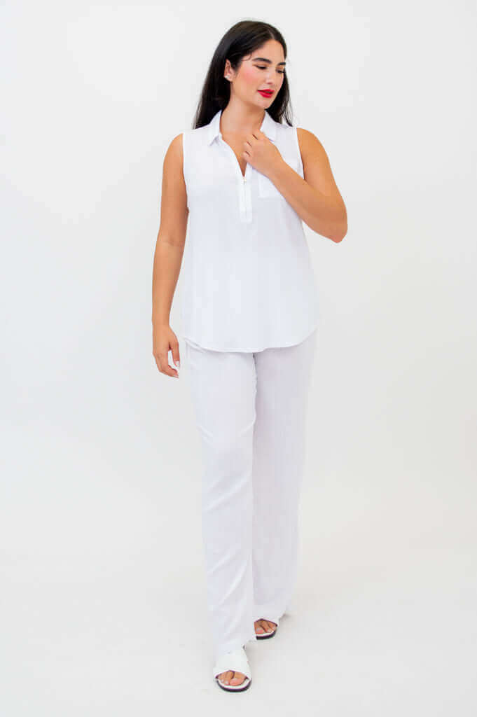 Woman walking in sleeveless white tank top and white pants