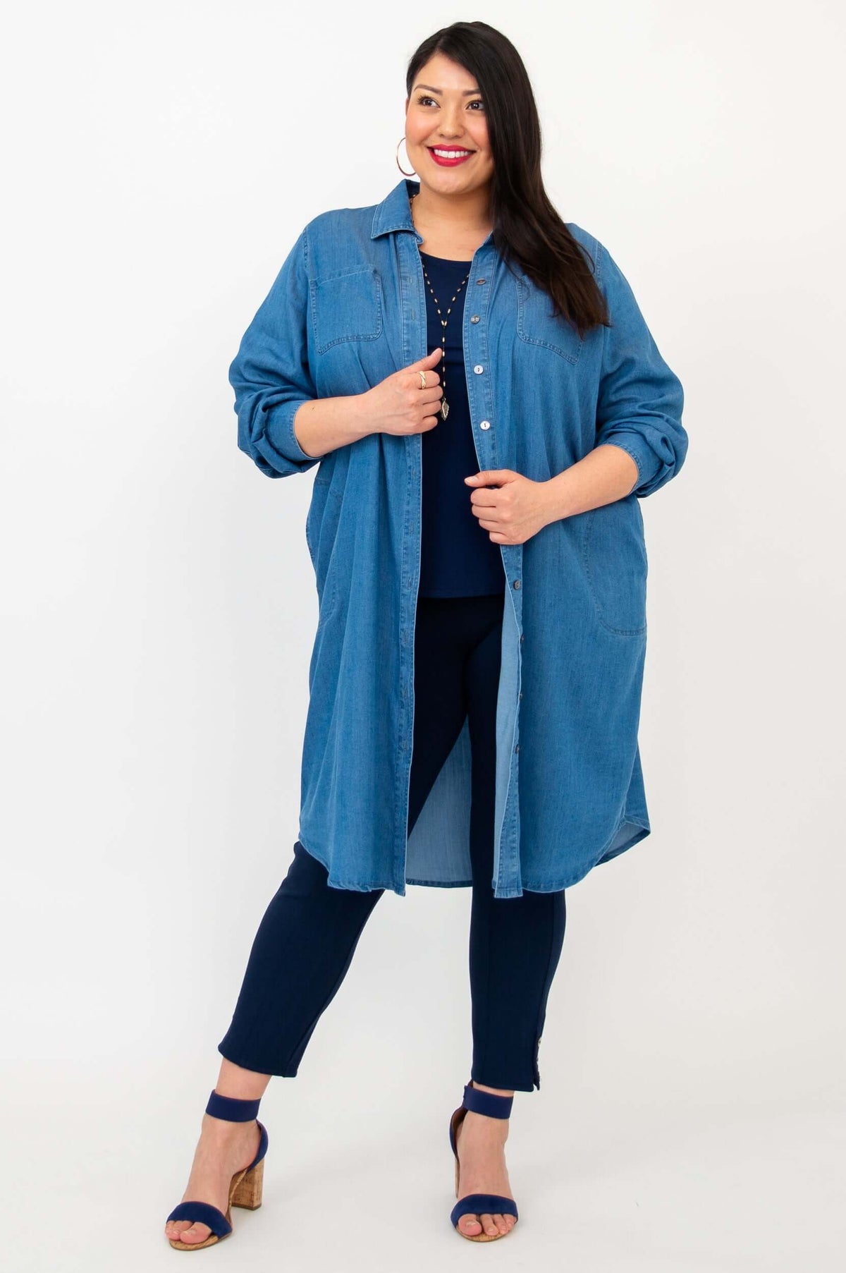 Woman posing in Anka denim duster, displaying the button-up front and full length