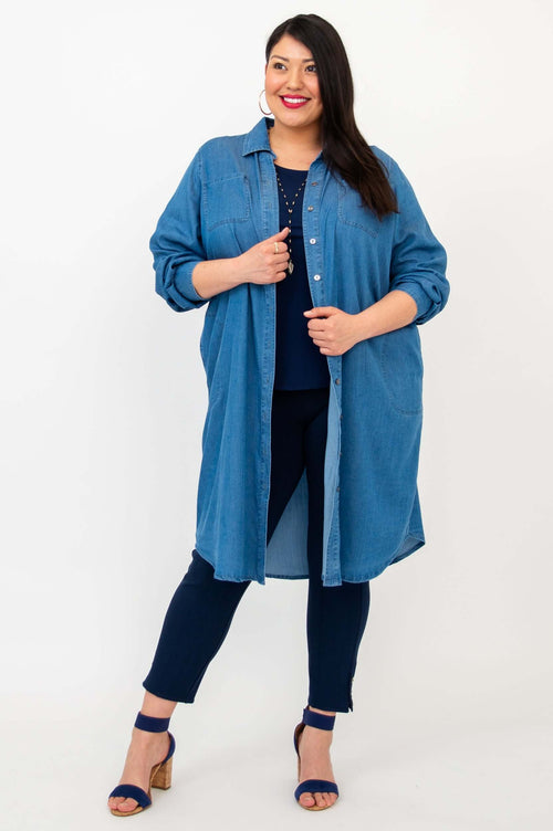 Woman posing in Anka denim duster, displaying the button-up front and full length