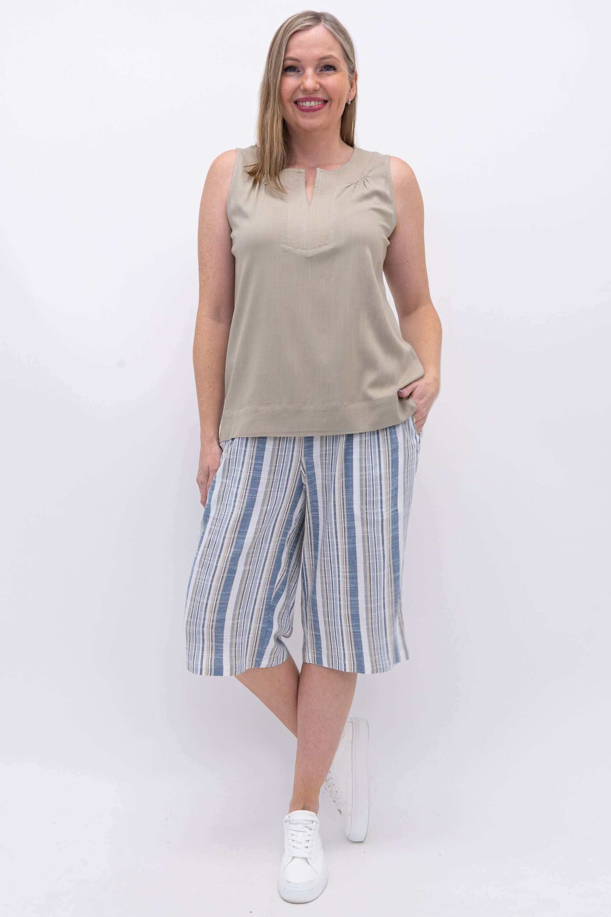Woman wearing Bambi Bermuda Stripe Shorts styled with beige sleeveless top