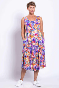 Model in sleeveless floral tank dress with hands in pockets