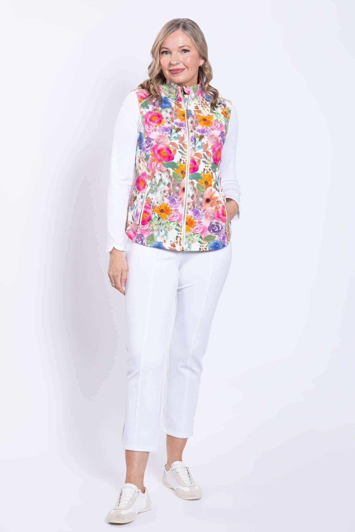 Three-quarter front view of woman modeling the Hartford Pink Print Vest and white pants