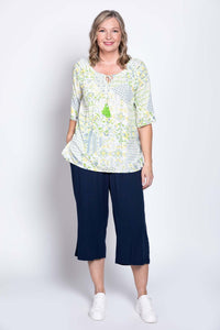 Woman modeling Luna Boho Peasant Top, styled with navy culottes and white shoes