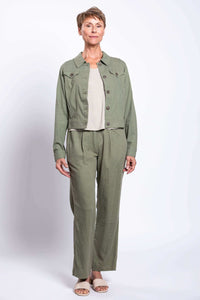 Full body view of model wearing olive green pants with a matching jacket