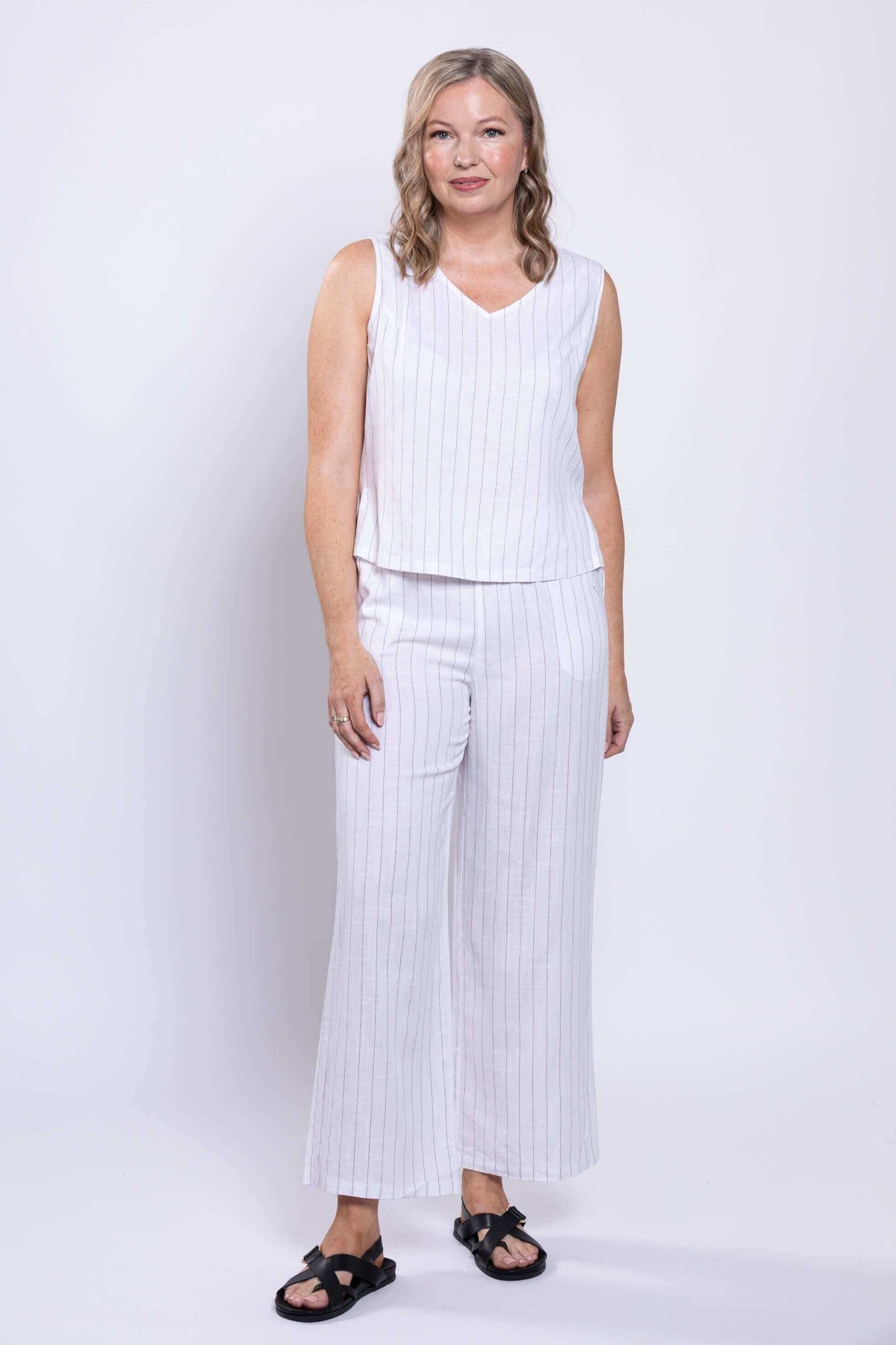 Model in white striped Parker Pant and matching sleeveless top, relaxed stance