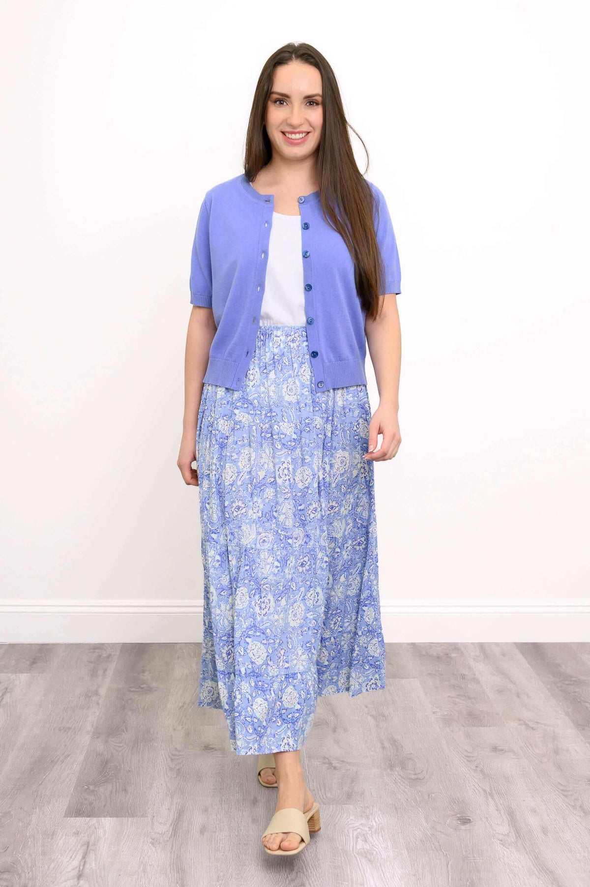 Model wearing Roma tiered blue floral skirt with short-sleeve cardigan