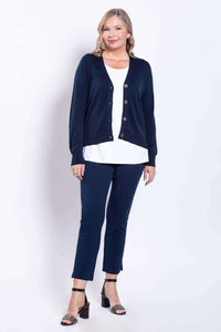 Model wearing navy slim-fit pants and navy cardigan, standing front facing
